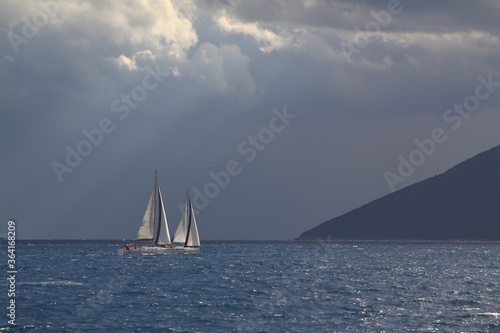 Sailing ship yachts with white sails in race the regatta in the open sea 