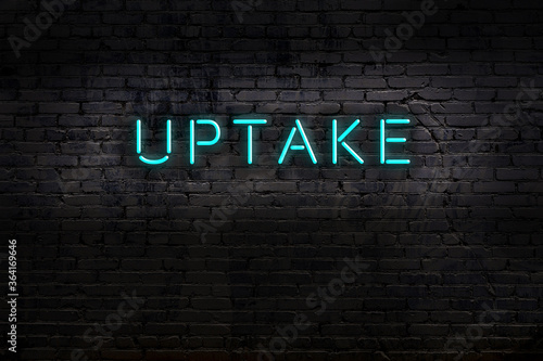 Photos Neon sign. Word uptake against brick wall. Night view