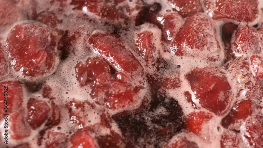 The process of making strawberry jam in its own juice with the addition of sugar in an open bowl on a gas stove macro video shooting The process of making strawberry jam in its own juice with the addition of sugar in an open bowl on a gas stove macro video shooting