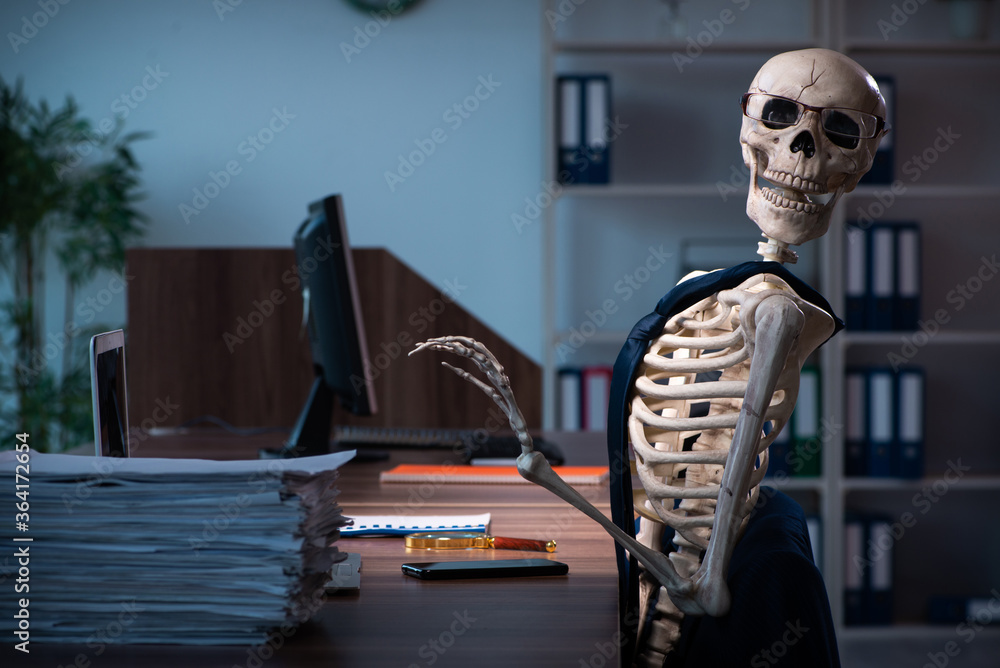 Young male employee working in the office night time Young male employee working in the office night time