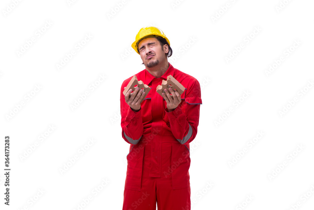 Young male mason with brick isolated on white Young male mason with brick isolated on white