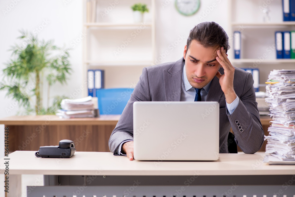Young male businessman unhappy with excessive work Young male businessman unhappy with excessive work