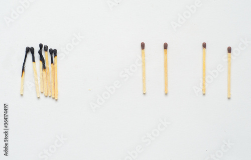 Social Distancing concept using burnt out match sticks as a metaphor for containing corona virus outbreak - health and medical concept.