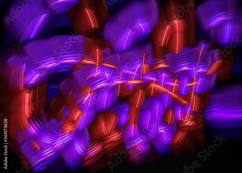 light painting abstract background. curves and waves of purple and red light against a black background