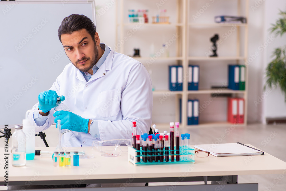 Young male chemist working in the lab Young male chemist working in the lab