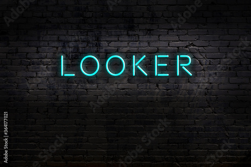 Neon sign. Word looker against brick wall. Night view