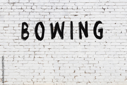 Canvas Print White wall with black paint inscription bowing on it