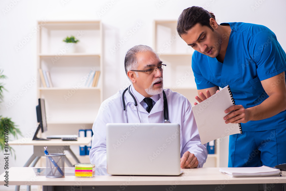 Two male doctors working in the clinic Two male doctors working in the clinic