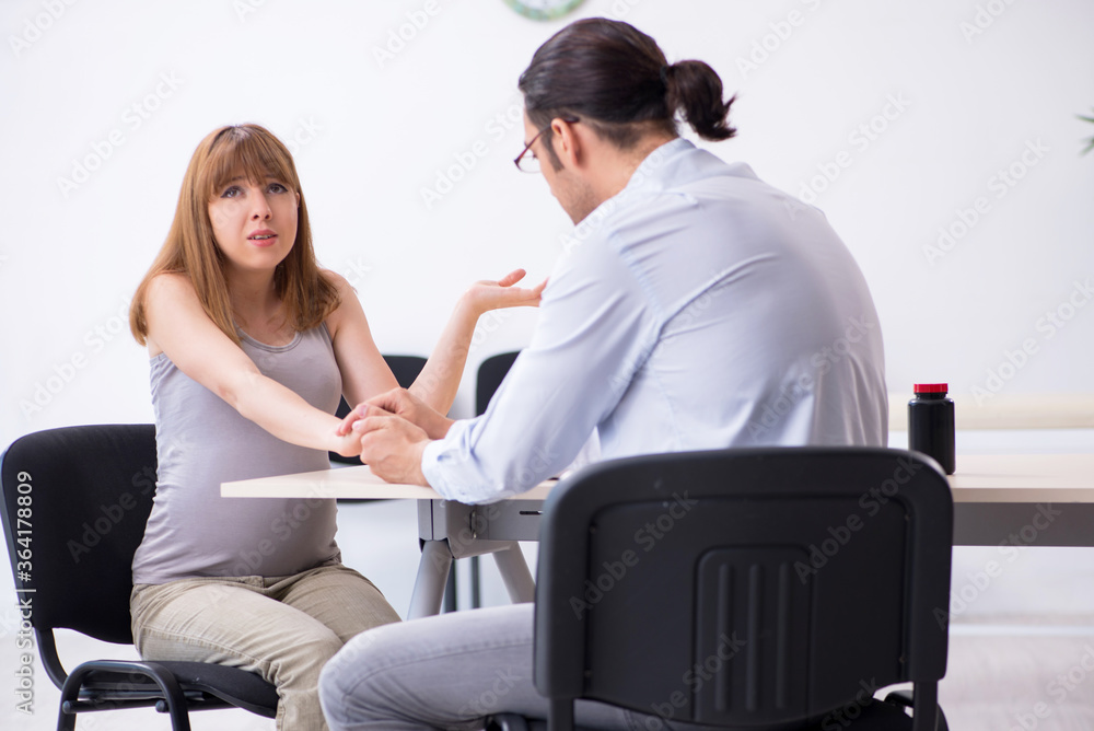 Pregnant woman visiting male psychologist doctor