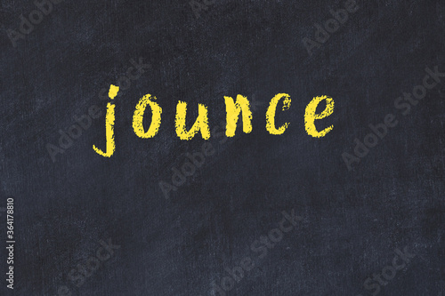College chalk desk with the word jounce written on in