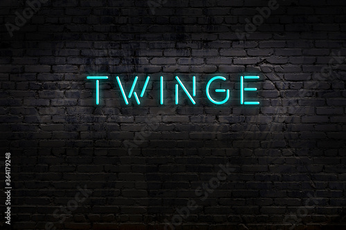 Neon sign. Word twinge against brick wall. Night view
