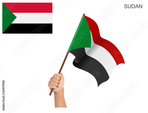 Flag of the State of Sudan raised with a stick held by hand to inflame the spirit of statehood