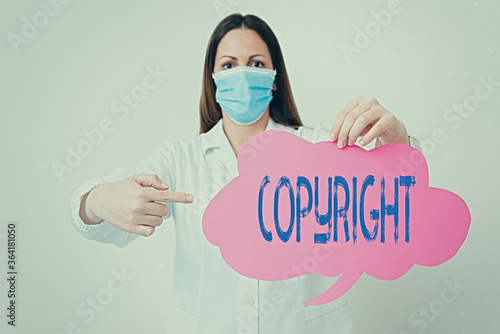 Conceptual hand writing showing Copyright. Concept meaning exclusive legal right to print write perform film record literary Laboratory technician featuring paper accessories smartphone