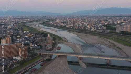 Crow flying over Gifu city, Japan at sunrise, Aerial view photo