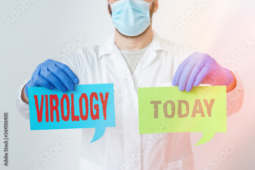 Writing note showing Virology. Business concept for branch of science dealing with the variety of viral agents and disease Laboratory Technician Featuring Sticker Paper Smartphone photo