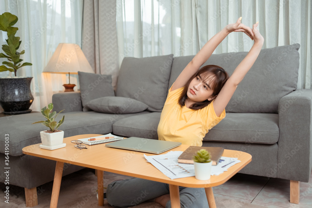 Young asian woman tried closing laptop relax from hard work at home. Young asian woman tried closing laptop relax from hard work at home.