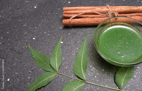 Medicinal Ayurvedic Azadirachta indica or Neem leaves with pestle with neem paste, juice and twigs.