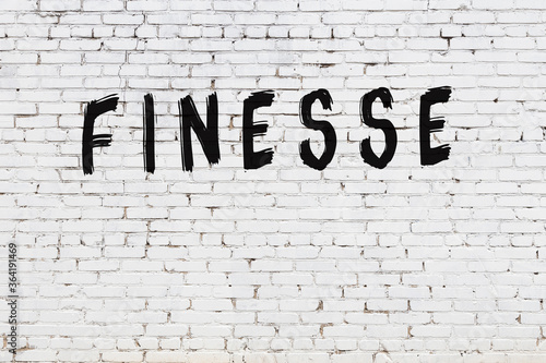 Obraz na plátne Inscription finesse painted on white brick wall