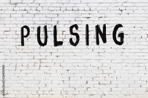 Фотография White wall with black paint inscription pulsing on it