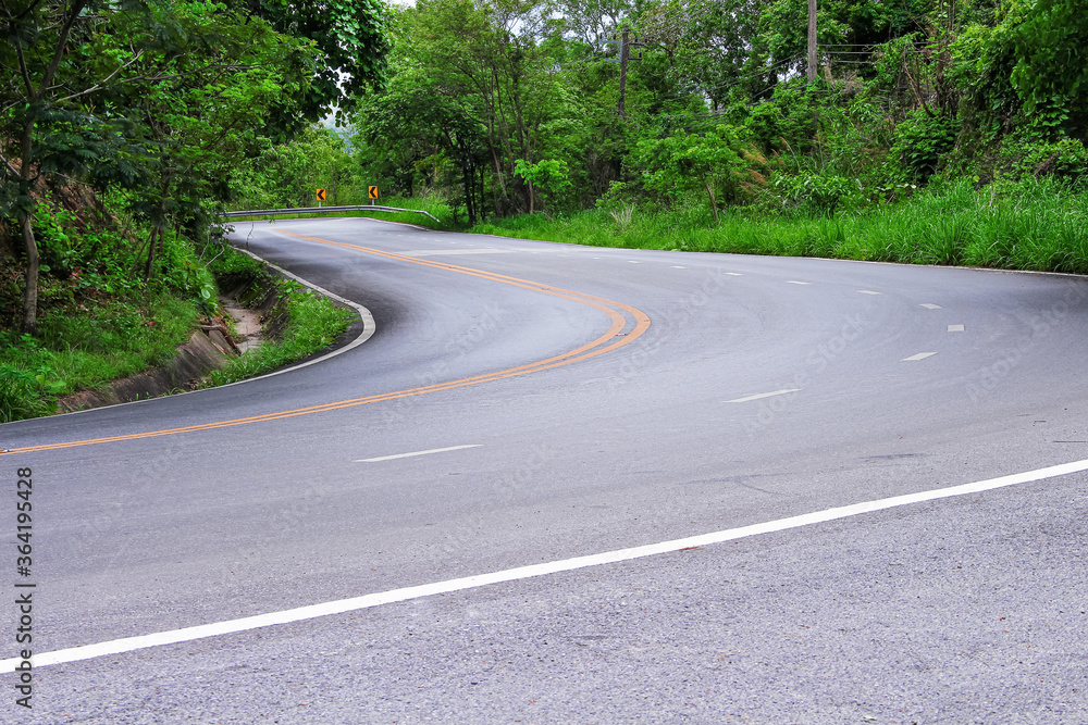 Landscape asphalt road with two yellow lines mark and nature tree in the side outdoor travel background Landscape asphalt road with two yellow lines mark and nature tree in the side outdoor travel background