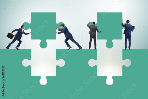 Businessman in teamwork concept with jigsaw puzzle