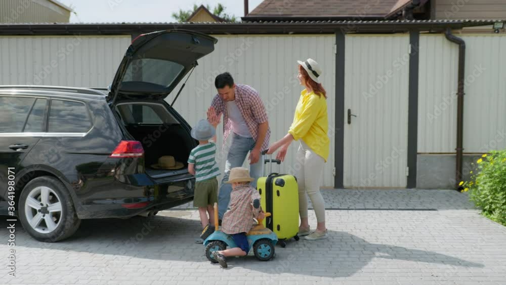 summer vacation, happy loving family with children going on trip by car load traveling suitcase in trunk for trip to summer resort summer vacation, happy loving family with children going on trip by car load traveling suitcase in trunk for trip to summer resort