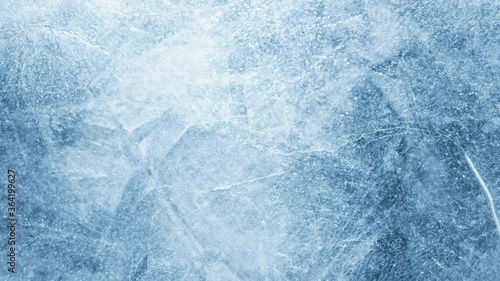 Close-up of melting ice texture. Studio shot close-up of the blue surface of cracked melting ice in time lapse.