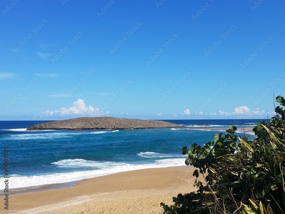 ocean water and waves with sand on beach in Isabela, Puerto Rico