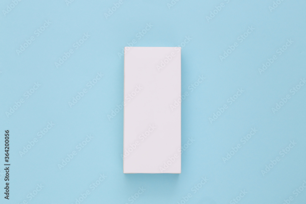 White packing box on blue background. Minimalism. Top view White packing box on blue background. Minimalism. Top view