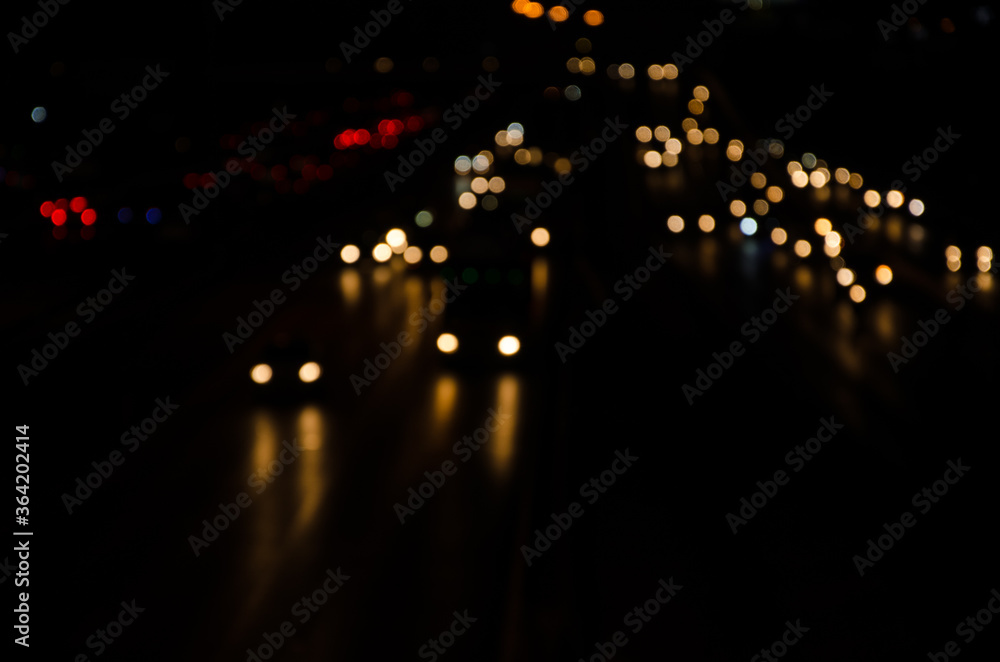 Blurred images of car lights on the road at night.