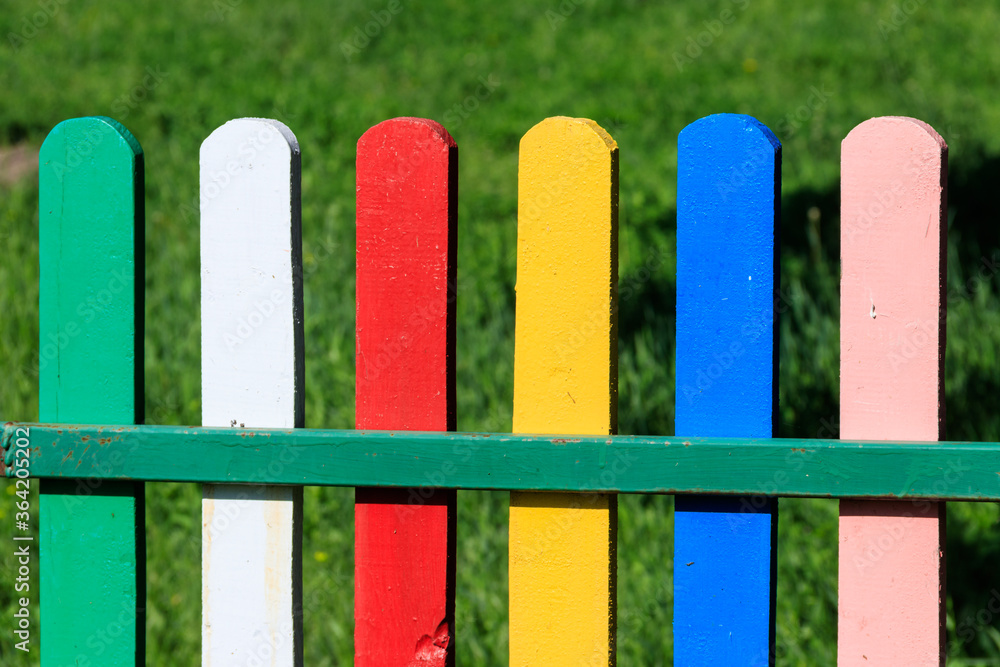 Close-up of the multicolored painted wooden fence