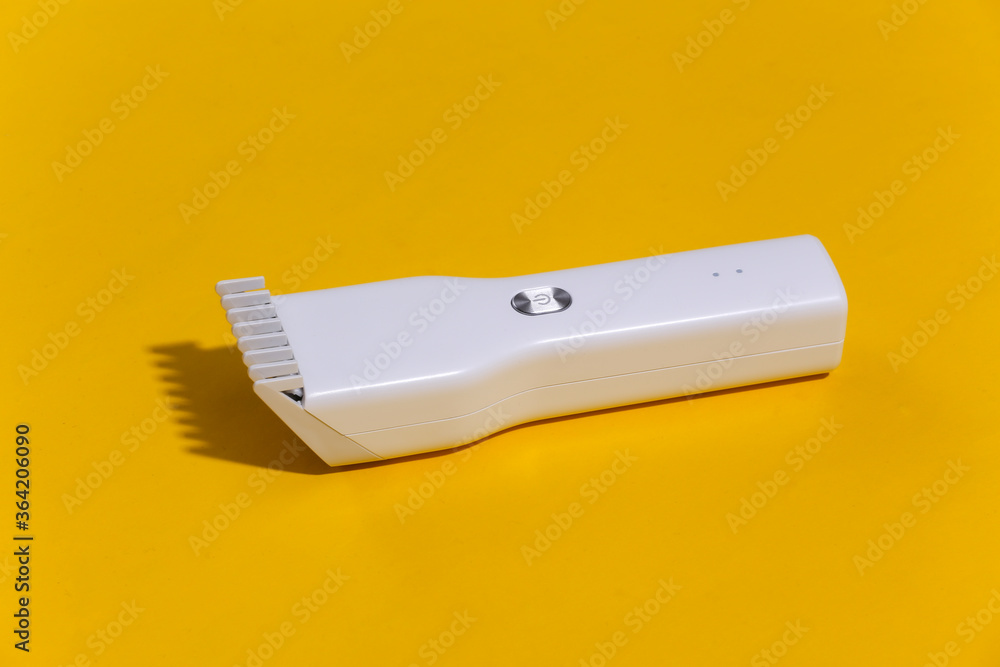 Wireless hair clipper on bright yellow background. Wireless hair clipper on bright yellow background.