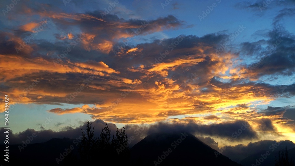 sunset over the mountains with colorful clouds