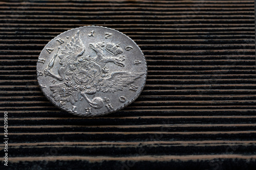 Numismatics. Old collectible coins made of silver, gold and copper on a wooden table. Top view.