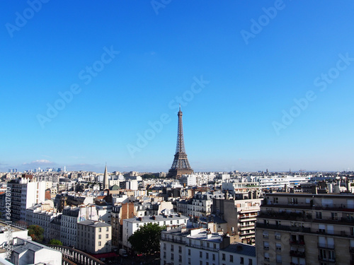  Paris skyline with the Eiffel Tower in the clear blue sky.