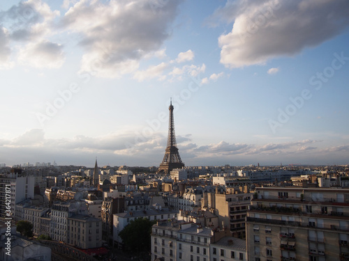 Paris skyline with big clouds in the cloudy sky and the Eiffel Tower