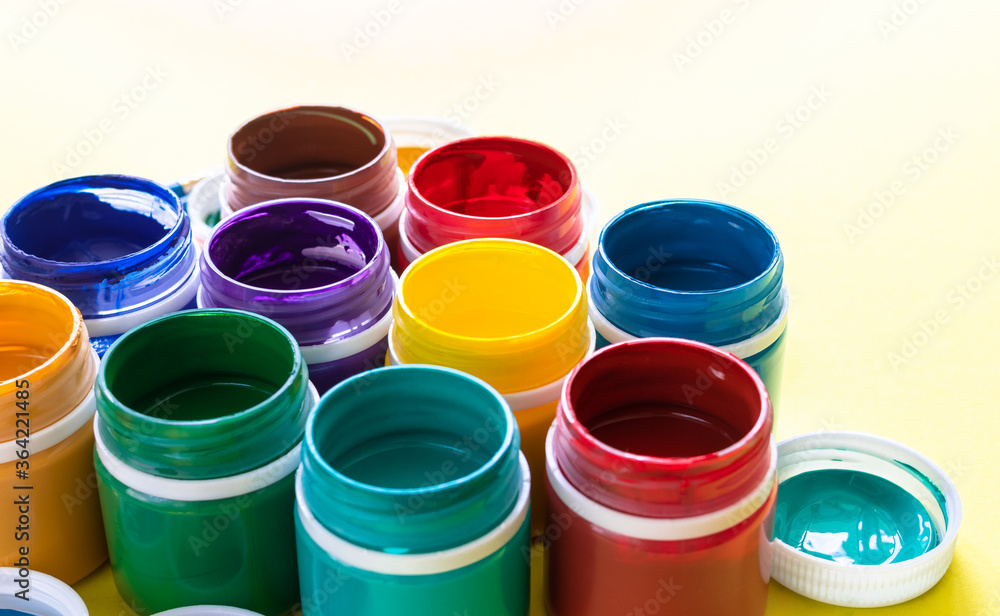 multicolored gouache paints in jars in close up multicolored gouache paints in jars in close up