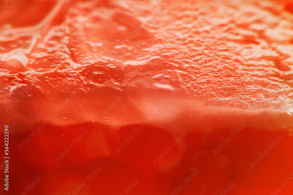 Background with sliced tomato under strong magnification in soft focus. A detailed image of the pulp of a ripe tomato. Background with sliced tomato under strong magnification in soft focus. A detailed image of the pulp of a ripe tomato.
