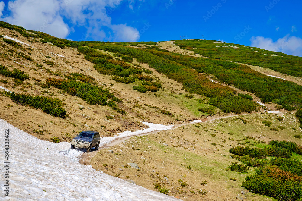 Off Road Car in Snow on the Road in Mountains 2