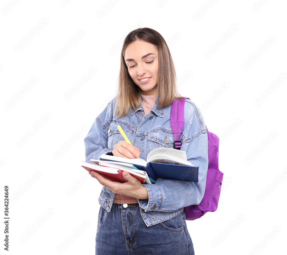 Cute student writes in a notebook on a white background Cute student writes in a notebook on a white background