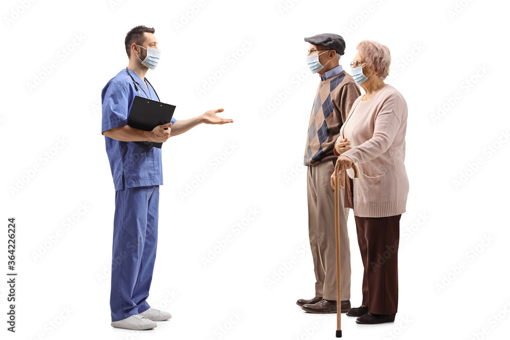 Medical worker with a face mask talking to an elderly man and woman