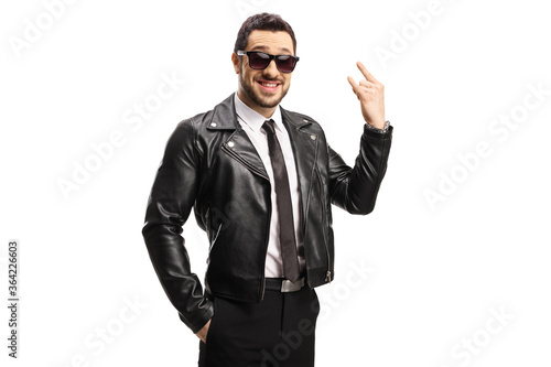 Young man in leather jacket gesturing a rock and roll sign