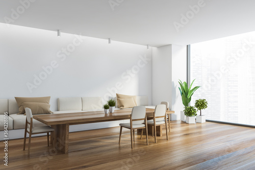 Panoramic white dining room corner with sofa