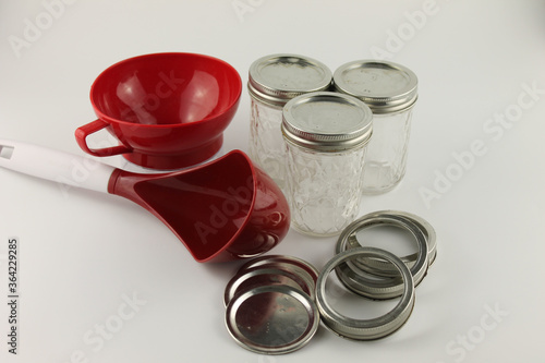Canning supplies, mason jars, rings, lids, wide mouth funnel and large red ladle