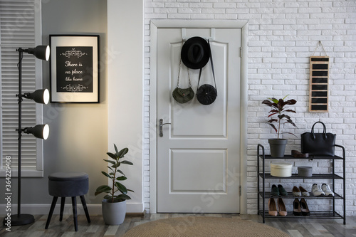 Billede på lærred Hallway interior with stylish furniture, shoes and plants
