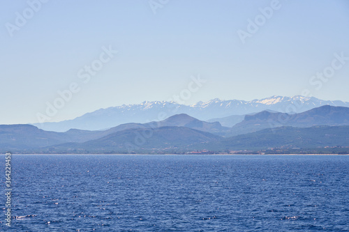 Fototapeta Naklejka Na Ścianę i Meble -  Foggy sea coast of Kolymbari, Crete, Greece with mountains and clear blue sky on a background.