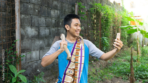 Asian man is happy while looking at his cellphone photo