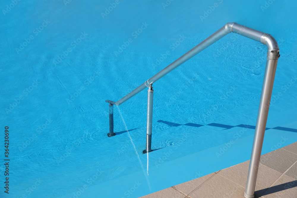 Modern swimming pool with step ladder. Summer vacation Modern swimming pool with step ladder. Summer vacation
