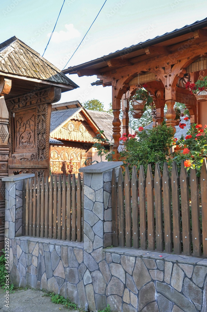 DESESTI, MARAMURES, ROMANIA, SUMMER 2018. Beautiful wooden houses on the way to the wooden orthodox church of San Parascheva or Desesti, Unesco World Heritage.