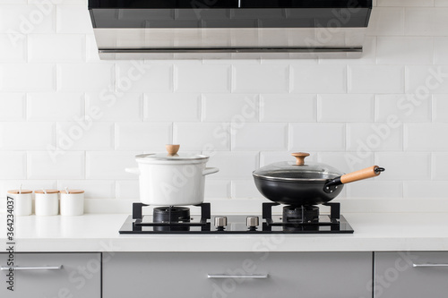 Photos close up of gas stove in white modern kitchen.